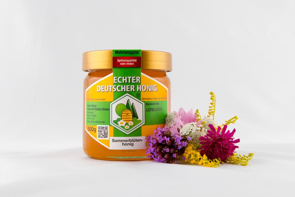 Brandingfotografie für Sommerblütenhonig mit den Blüten am Rand